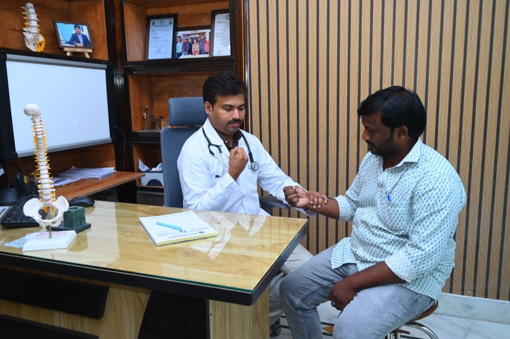Dr. Tejo Phanindra P examining a patient